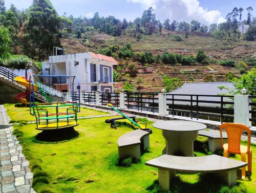 a park with a playground with a table and chairs at REGALIA ROOMS KODAI in Kodaikānāl