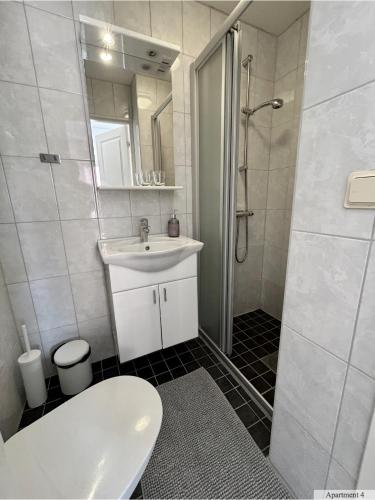 a bathroom with a sink and a shower and a toilet at C Apartments Annedal in Gothenburg