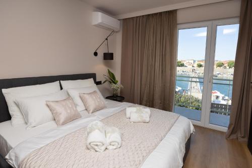a bedroom with a large bed with towels on it at Aurum Ponte Deluxe in Zadar