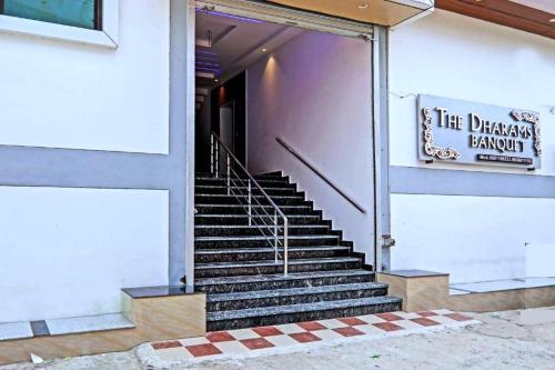 a set of stairs in a building with a sign at The Dharams Hotel in Lucknow