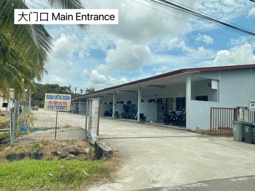 a large white building with a main entrance at Nature Camp House 2km Jeti Mersing Centre in Mersing