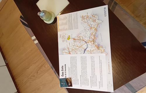 a ticket on top of a table with a map at Casa Evita in Sanxenxo