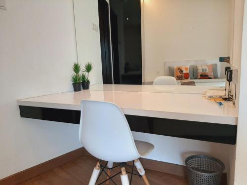 a white desk with a white chair in a room at Symphony Tower Studio #9 with balcony in Cheras