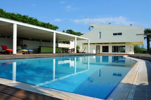 a large swimming pool in front of a house at Villa Temptation in Kamena Vourla