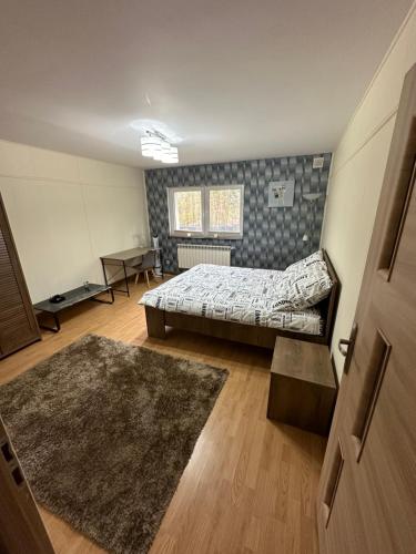 a bedroom with a bed and a rug at Drift Away in Mielno