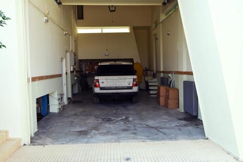 a garage with a car parked in it at Villa Temptation in Kamena Vourla