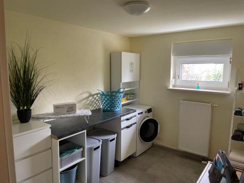 a small kitchen with a washer and dryer in it at Palais -MehrGehtNicht-Maisonette in Großweitzschen