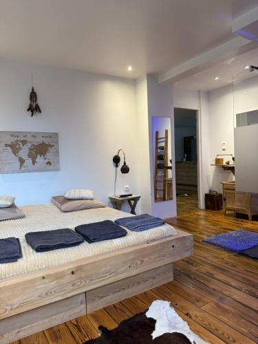 une chambre avec un grand lit avec des oreillers bleus dessus dans l'établissement MONTAGNE-LAC&SPA (jacuzzi privé) (NOUVEAU), à Anould