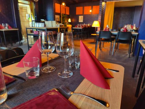 uma mesa com guardanapos vermelhos e copos de vinho em WatchHouse em Hamina