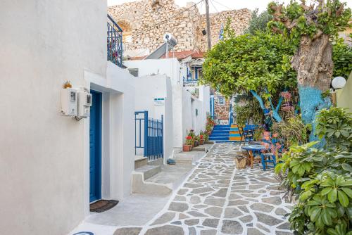 a narrow alley in a town with white buildings at Pythagorio Blue Street Apartment with Balcony in Pythagoreio