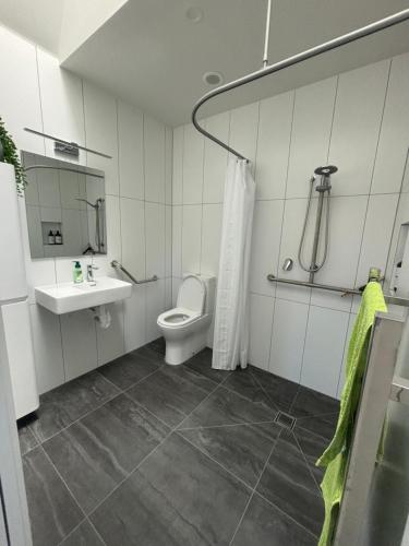 a bathroom with a toilet and a sink at Totara Ridge in Rotorua