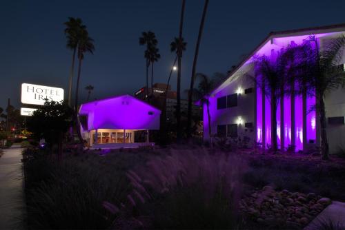 a building with purple lights on it at night at Hotel Iris - Mission Valley-San Diego Zoo-SeaWorld in San Diego
