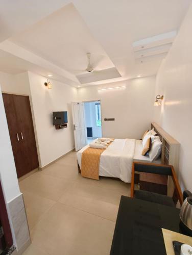 a hotel room with a bed and a television at PAUL RESIDENCY in Nedumbassery