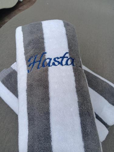 a black and white towel with the word hastoria on it at Hasta La Vista Villa Amed in Amed