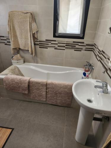 a bathroom with a bath tub and a sink at Club hipica la ferme de montroy in Polop