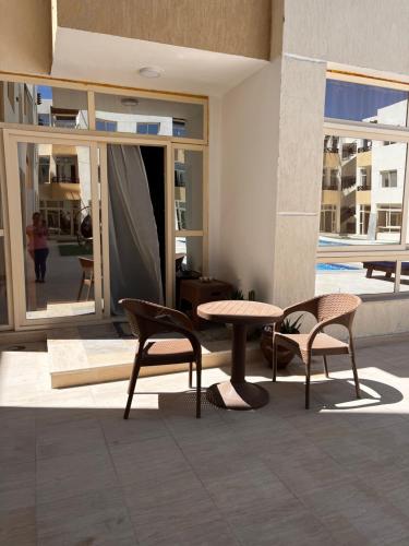 a room with a table and two chairs and a table at Port Ghalib Apartments in Port Ghalib