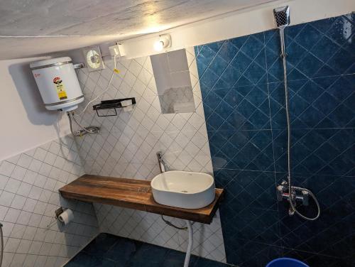a small bathroom with a sink and a shower at Resort Blue Lotus in Almora