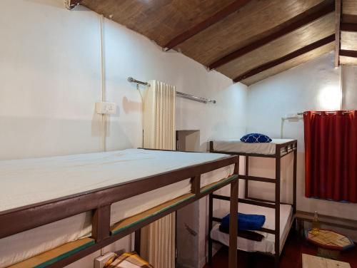 a room with two bunk beds in it at Resort Blue Lotus in Almora