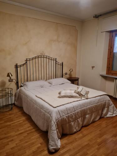 a bedroom with a bed with a blanket on it at Locanda di Sandro in Monsummano Terme