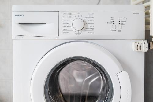 a white washing machine with its door open at Roma 23, SmartStay Rozzano in Rozzano
