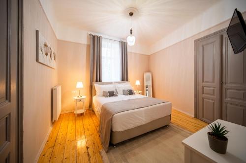a bedroom with a bed and a large window at Oikia Tripodon in Athens