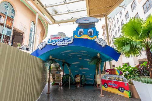 a entrance to a disney lagoon resort with a sign at Resort Suites at Pyramid Tower by GL Staycation in Petaling Jaya