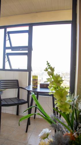 a table and a chair in a room with a window at 456 Hotel in Baguio
