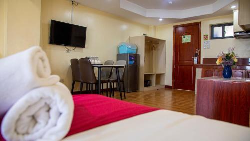 a hotel room with a bed and a table with chairs at 456 Hotel in Baguio