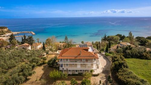 an aerial view of a house with the ocean in the background at Swan Apartment 3 in Zakynthos Town