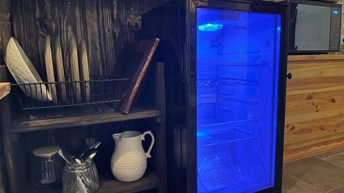 a cabinet with a blue door and a vase and utensils at Fisherman's hut in ‘Akko