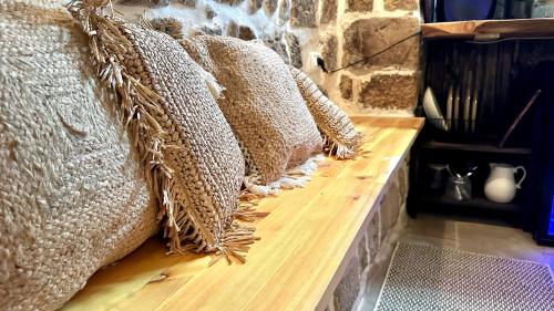 a row of pillows sitting on a wooden bench at Fisherman's hut in ‘Akko