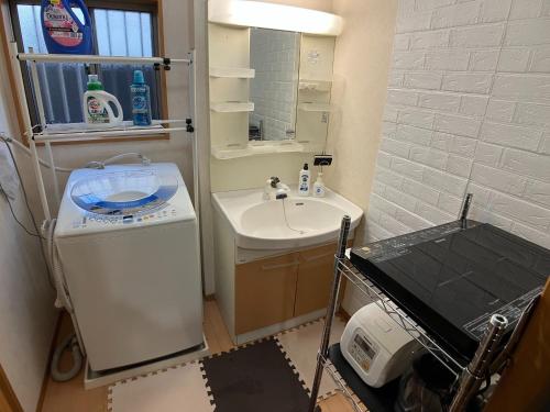 a small bathroom with a sink and a mirror at Akane Shimada House - Vacation STAY 13990 in Narashino