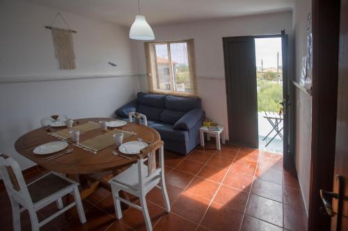 ein Wohnzimmer mit einem Tisch und einem blauen Sofa in der Unterkunft Ria de Aveiro White House in Murtosa