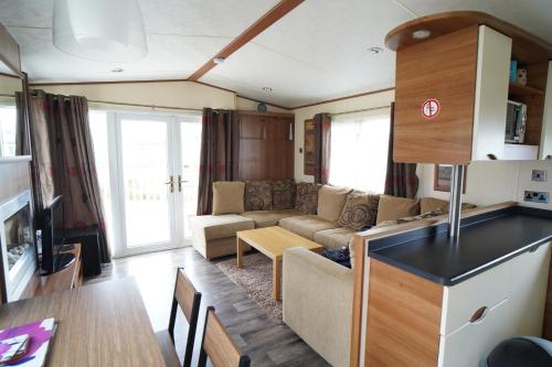 a living room with a couch and a table at Caravan - Sleeps 8 - Pets Ok - Parking in Hunstanton