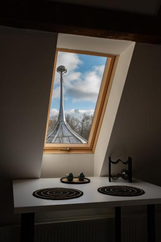 a window over a stove with a picture of the eiffel tower at Apartament Loftowy Ordona 5 in Szczecinek