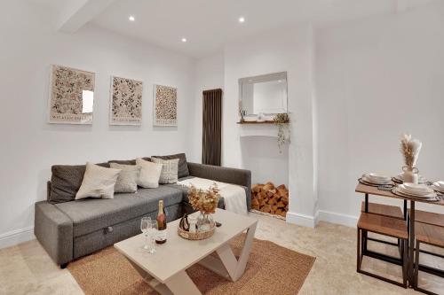 a living room with a couch and a table at The Bay Escape -Lovely 3bd house in Cardiff