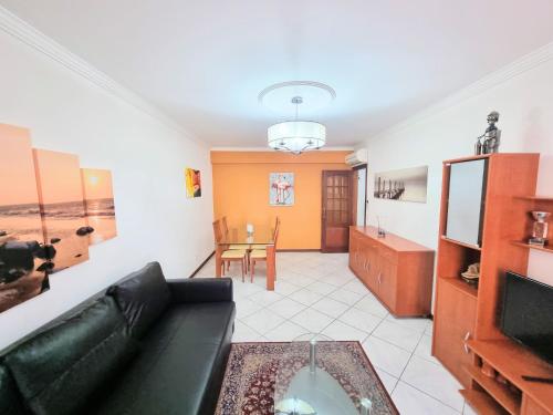 a living room with a couch and a table at Apartamento Real Delux in Vila Real de Santo António