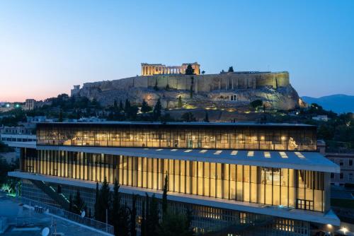 a building with a castle on top of a mountain at Coco-mat Athens BC in Athens