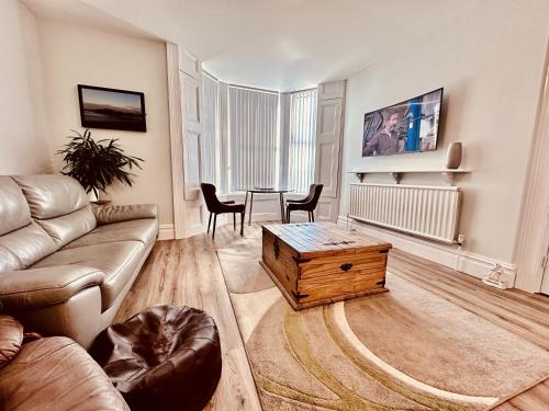 a living room with a couch and a coffee table at The Kyrenia in Weston-super-Mare