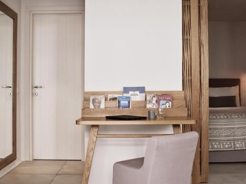 a room with a table with a mirror and a chair at Boho Private Luxury Suites in Mýkonos City