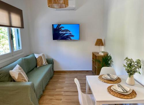 a living room with a couch and a table at Oliva - 1 bedroom apartment in Benitses