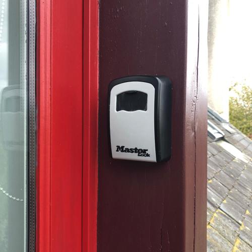 a black and white toaster on a red door at Ecrin de Verdure in Sainte-Suzanne