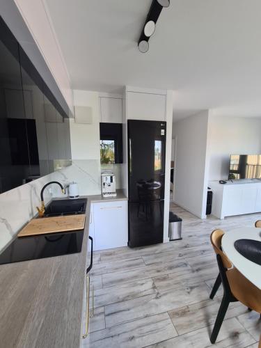 a kitchen with a sink and a counter top at Modrzewiowy Zakątek in Augustów