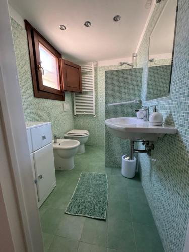 a bathroom with a sink and a toilet at Zaira House in Torre Suda