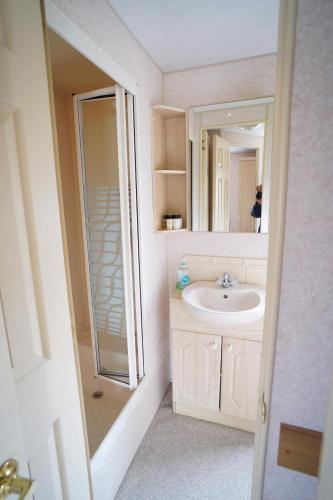 a bathroom with a sink and a mirror at 2 Bedroom caravan Hunstanton pets go free in Hunstanton