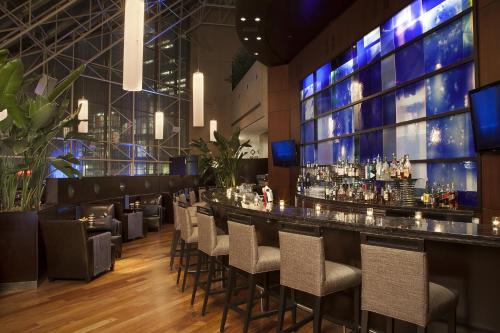 a bar in a restaurant with a bunch of stools at InterContinental Toronto Centre by IHG in Toronto