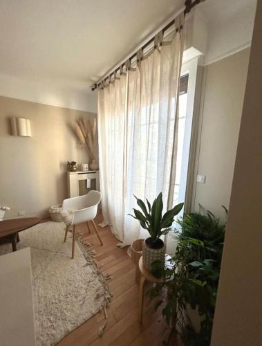 un salon avec une chaise et une fenêtre dans l'établissement Boheme Chic house, à Paris