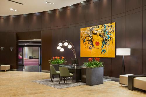 a lobby with a large painting on the wall at InterContinental Toronto Centre by IHG in Toronto