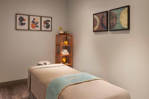 a hospital room with a bed and pictures on the wall at InterContinental Toronto Centre by IHG in Toronto