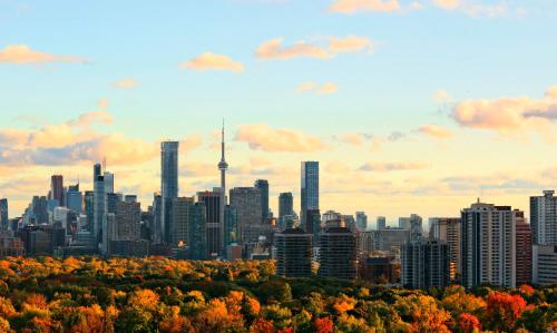 a city skyline with the cn tower in the background at InterContinental Toronto Centre by IHG in Toronto